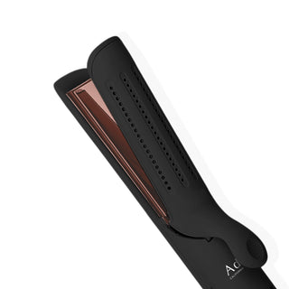 An Adagio Airlock Styler Pro (with XL Rose Gold Plates) in black, featuring vents along one side and extra-large rose gold heating plates, is displayed against a white background. The device is partially open, highlighting the details of the heating plates and showcasing its professional design.