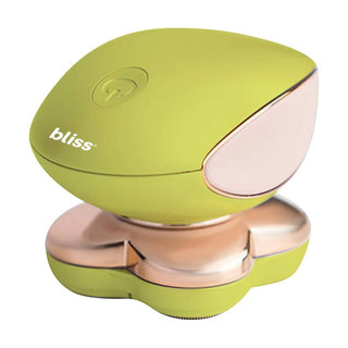 The bliss Electric Total Body Shaver is a compact handheld device in green and gold, with a sleek, modern design that includes a flower-shaped base and the brand name "bliss" printed on the green top. It features 18-karat gold-plated floating heads for painless precision shaving and also functions as an electric massager. A power button is conveniently located on the top.