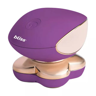 A handheld massage device in purple and metallic gold with the brand name "bliss" written in white on the side. This ergonomically designed device features a top button for easy operation and boasts 18-karat gold-plated floating heads for a luxurious experience.