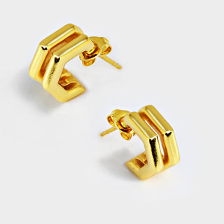 A pair of Futuristic Double Hexagon Chubby Huggies by Sonia Hou Jewelry, featuring a modern and angular design, are displayed against a white background. These gold earrings have a distinctive rectangular shape that forms a partial loop, offering a minimalist and contemporary aesthetic. They are perfect for adding a unique touch to your ear stack.