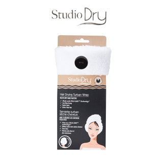 Packaging for the Studio Dry 20X QuickDry Turban Hair Towel (2-Pack). The package includes two white microfiber hair towels, each featuring an illustration of a woman wearing it on the front. Product descriptions tout quick hair drying, moisture-wicking properties, eco-friendliness, and protection against heat damage.